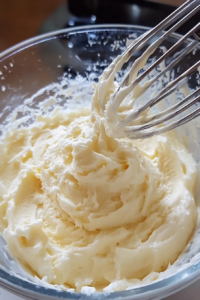 Close-up shot of the lemon pie filling being poured into the prepared cookie crust. The filling smoothly settles into the base, ready to be refrigerated and set. The pie dish is placed in the fridge to firm up.