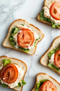 The same bread slices now layered with thick slices of pepper jack cheese, with flecks of jalapeño visible in the creamy cheese. The sandwich fillings are coming together, promising a deliciously melty texture.