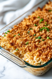 A fully baked Chicken and Rice Casserole, fresh out of the oven, sitting on the white marble cooktop. The golden-brown, crispy cracker topping glistens under the light, perfectly baked and ready to be served as a comforting meal.