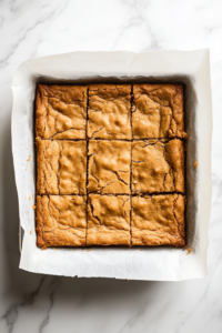 A golden-brown cookie bar slab cooling in the pan after baking for 30 minutes.