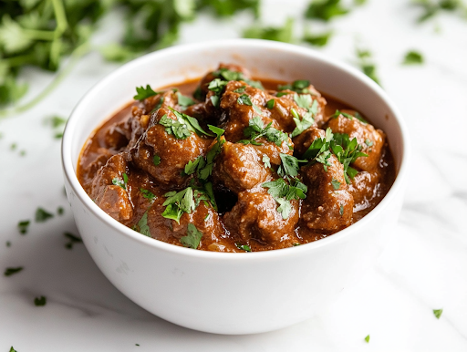 A close-up shot of a rustic bowl filled with steaming slow cooker beef stew, garnished with fresh parsley. A slice of crusty bread rests on the side, ready to soak up the flavorful broth, completing this cozy, homemade meal.