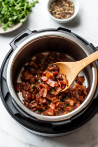A close-up of an Instant Pot set to 'Sauté' mode on a white marble countertop. Inside, diced bacon sizzles to a golden crisp as a wooden spoon stirs it. A small dish of seasonings and fresh herbs sits nearby, ready to enhance the dish.
