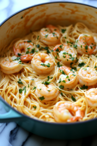 A pot of freshly mixed Bang Bang Shrimp Pasta resting for five minutes, allowing the sauce to thicken. The noodles glisten with creamy sauce