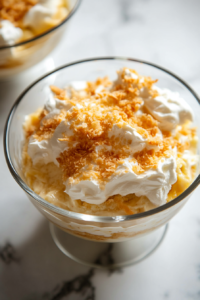 The set pudding is being gently folded into the coconut whip, creating a light and creamy banana custard mixture