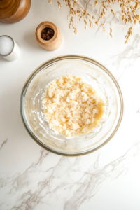A mixing bowl with softened cream cheese, sugar, and vanilla being beaten together into a smooth, creamy filling.