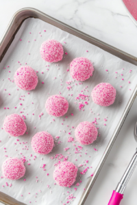 A tray of freshly baked pink cookies cooling on a wire rack, ready to be enjoyed after reaching the perfect texture.