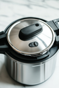 A close-up shot of the Instant Pot lid being securely closed over a white marble cooktop. The steam valve is carefully turned to the 'Sealing' position, ensuring the flavors are locked in for the cooking process.
