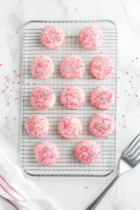 A tray of freshly baked pink cookies cooling on a wire rack, ready to be enjoyed after reaching the perfect texture.