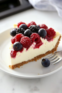Arranging fresh berries on top of the chilled cheesecake.