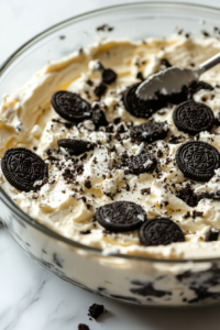 Whipped cream and crushed Oreo pieces gently folded into the chocolate cream cheese mixture.