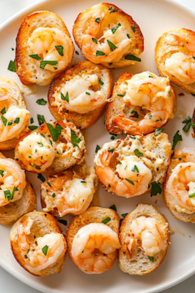 A serving plate on the white marble cooktop, beautifully arranged with golden shrimp and cheese baguette bites. Garnished with extra shrimp and fresh herbs, they are warm and ready to be enjoyed.