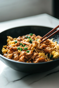 A black wok on a white marble cooktop where thinly sliced shiitake mushrooms and celery strips are being stir-fried. The vegetables glisten as black pepper and soy sauce coat them evenly, enhancing their flavor.