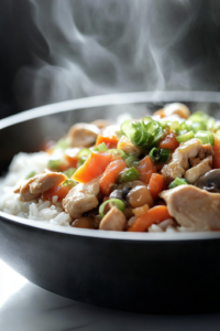 A steaming bowl of Chicken and Vegetable Rice Skillet, garnished with freshly sliced green onions. The dish is vibrant, hearty, and beautifully presented, ready to be enjoyed.